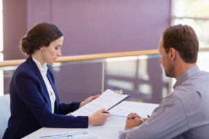 Business executives discussing over document at conference centre